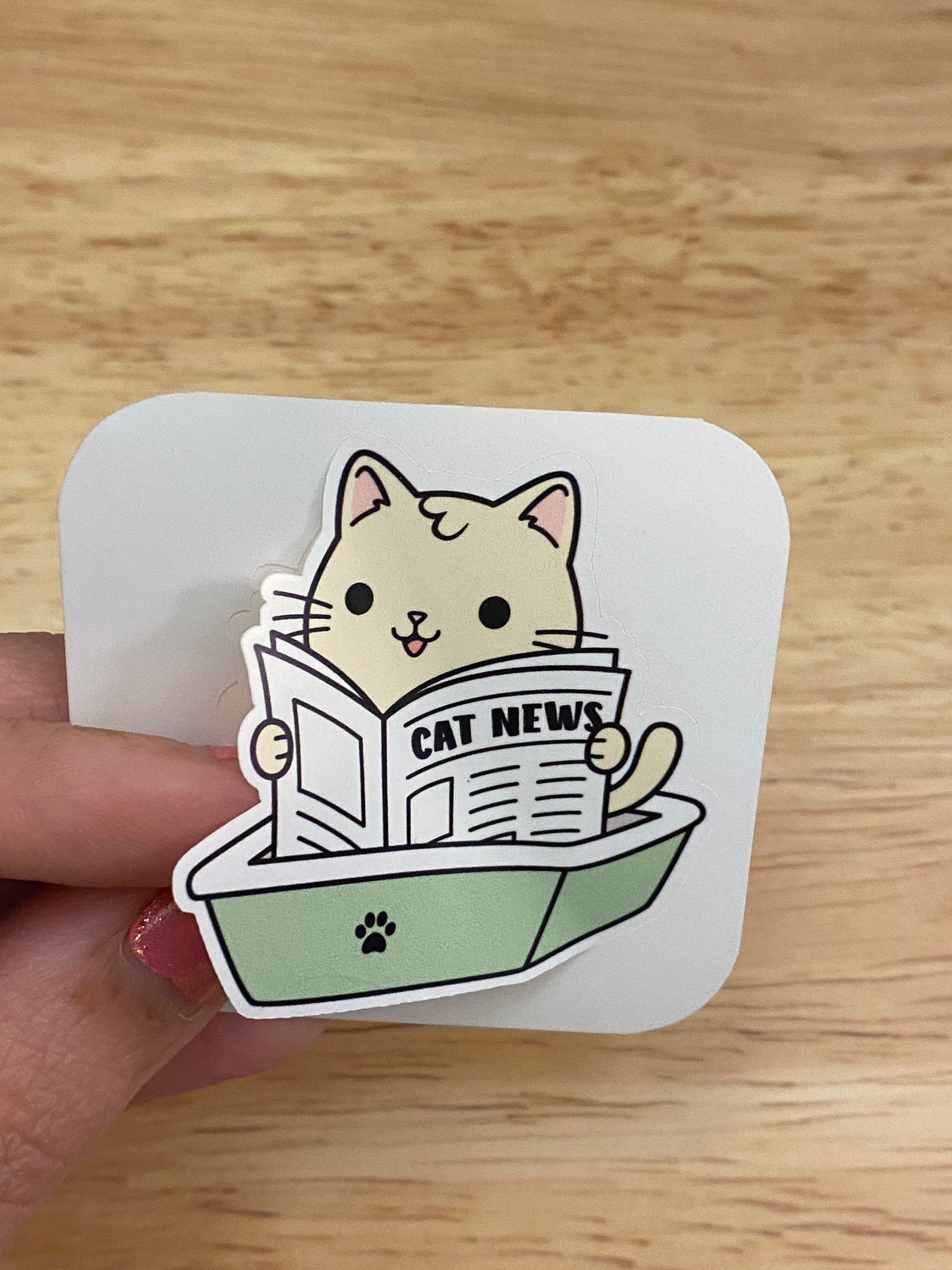 Cat using the litter box Sticker